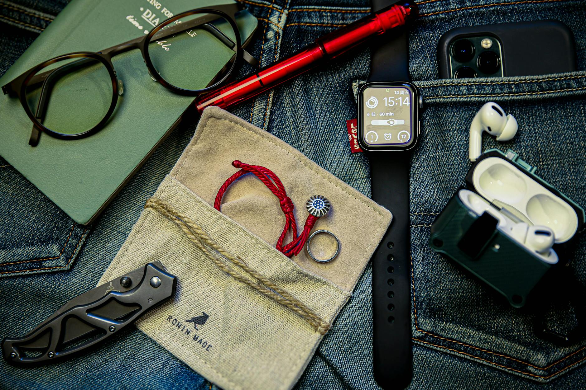 EDC flat lay with pocket knife on denim, illustrating OTF pocket carry setups
